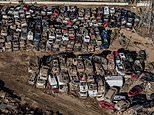 Valencia’s car graveyard: Dramatic pictures show row upon row of mangled cars after they were swept away in deadly Spanish floods