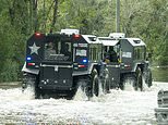 Rescue crews use all-terrain vehicles to visit homes after floods savaged Tampa during Hurricane Milton