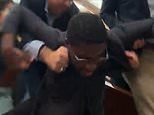 Democratic congressional candidate is dragged out of hearing and pummeled to the ground