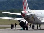 Man ‘commits suicide’ by ‘throwing himself’ into passenger jet engine after running on to the runway as plane prepared for take-off