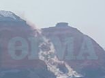 Moment massive landslide crashes into the sea in Santorini engulfing village with dust as tourists watch on