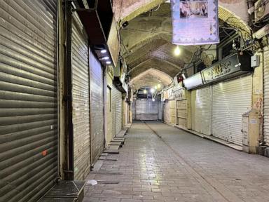 Security forces clash with protesters in Iran’s main market as at least 35 killed in demonstrations